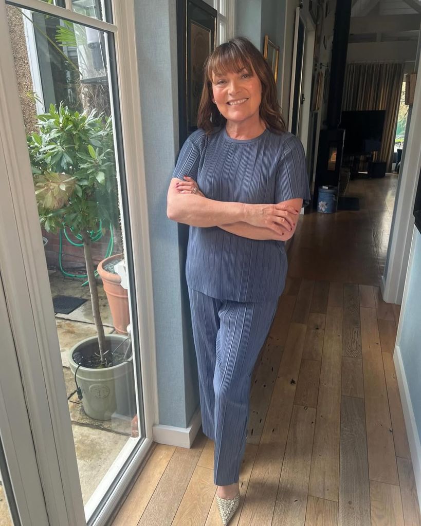 Lorraine Kelly in the hallway of her home with her living area in the background