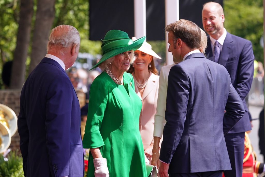 Kate curtseying to the King and Queen as they greet the Macrons