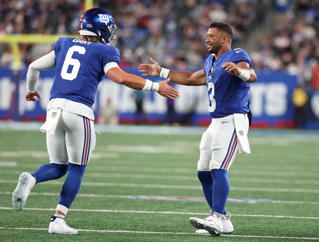 Jaxson Dart #6 of the New York Giants celebrates a touchdown against the New England Patriots with Russell Wilson #3  during their NFL Preseason game at MetLife Stadium on August 21, 2025 in East Rutherford, New Jersey