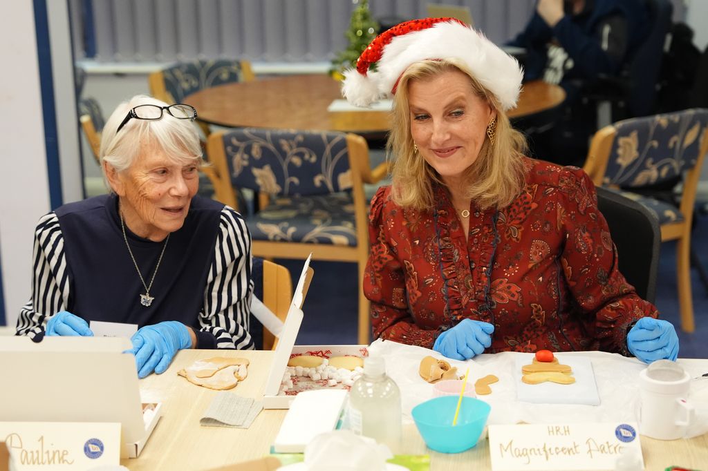 Sophie decorating biscuits and wearing santa hat