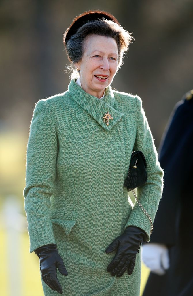 Princess Anne smiling in green tweed coat