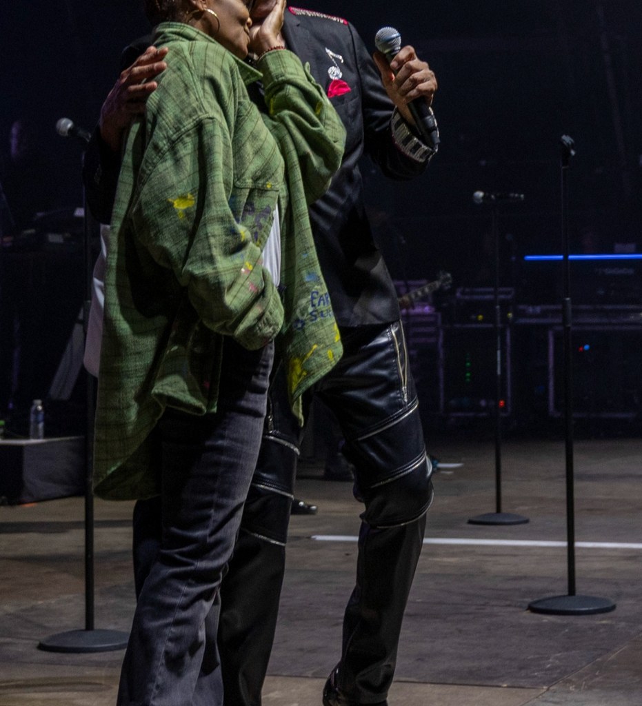 Photo shared by Heritage Live on Instagram July 2025 of Janet Jackson embracing one of her brothers during a surprise appearance in England