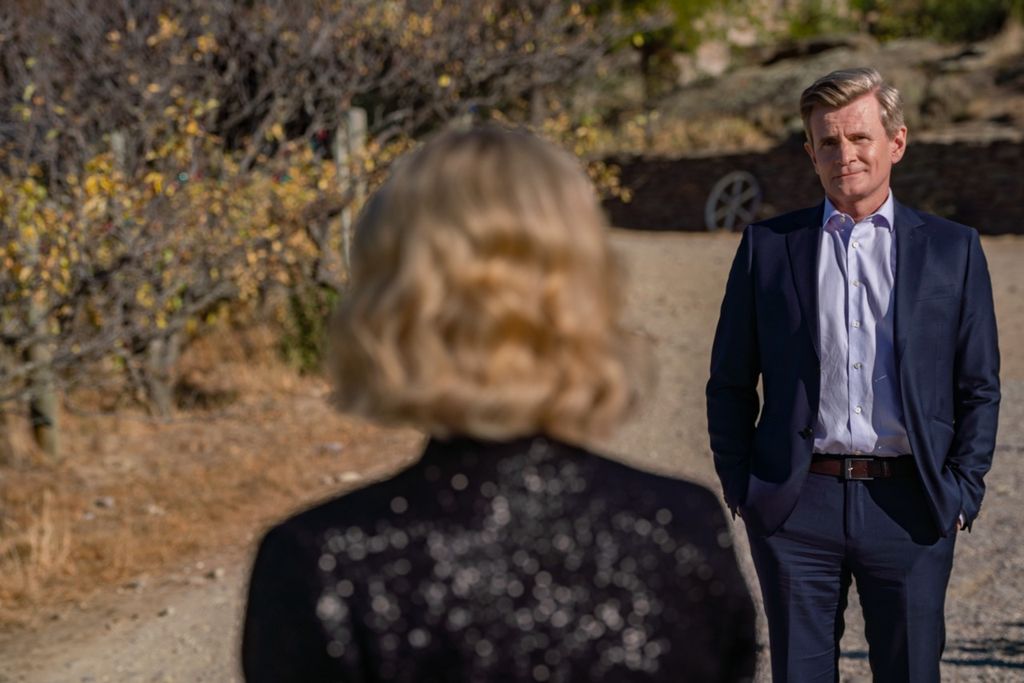 man in suit looking at woman