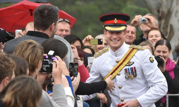 Prince Harry smiling wearing a militar uniform