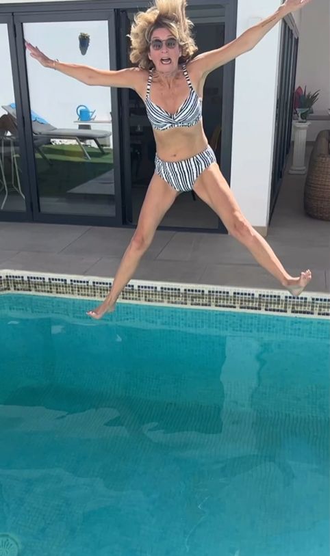 Kaye Adams in a bikini jumping into a pool