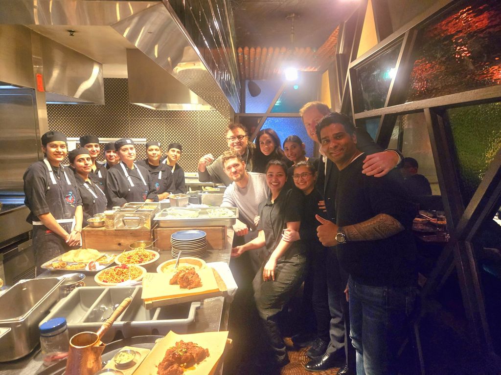 Prince Harry (second right) at Vij's in Vancouver with Meghan and Michael Buble