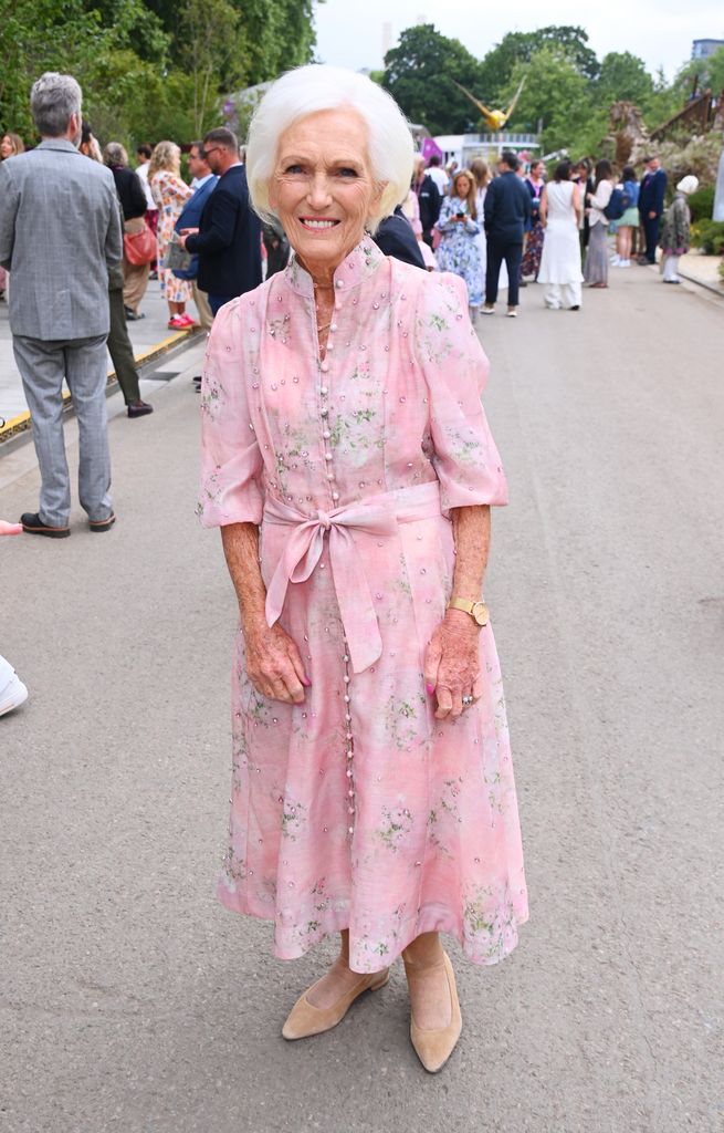 Mary Berry wears a pale pink floral midi dress with pearls and a bow belt at Chelsea Flower Show.