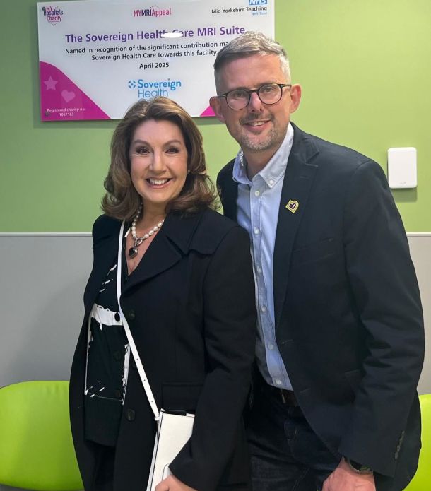 Jane McDonald in a black outfit standing with a man