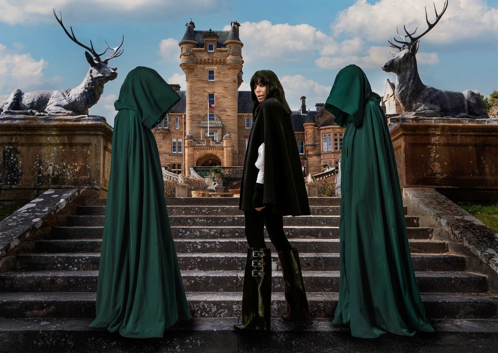 Claudia Winkleman on the steps to a castle with two cloaked figures