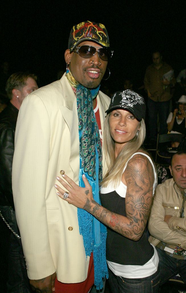 Dennis Rodman (L) and Michelle Moyer pose in the front row at the Christian Audigier Fall 2007 fashion show during Mercedes Benz Fashion Week held at Smashbox Studios on March 21, 2007 in Culver City, California