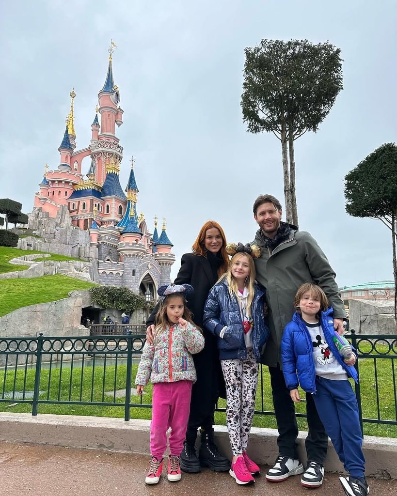 Jensen Ackles and wife Danneel pose with their three kids in front of the Magic Castle in Disneyland