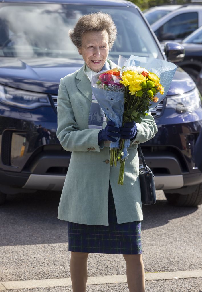 Princess Anne holding a bouquet of flowers