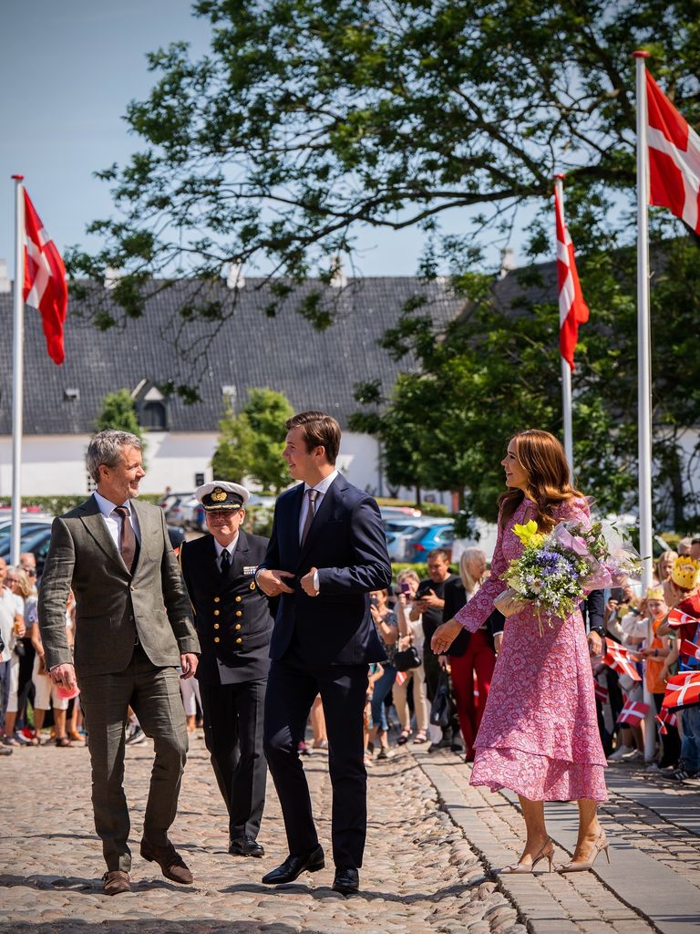 Queen Mary outside with king frederik and prince christian 