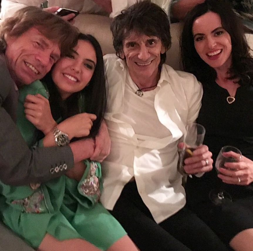 Mick Jagger embracing Noor Alfallah while with Ronnie Wood and Sally Humphreys