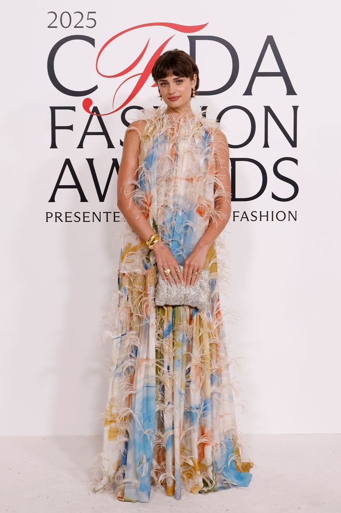 Taylor Hill attends the 2025 CFDA Awards at American Museum of Natural History in a pastel feathered dress