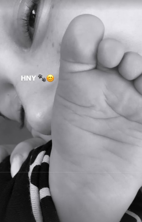 Hailey Bieber kisses her baby son Jack's foot