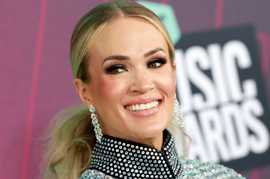 Carrie Underwood at 2023 CMT Music Awards in silver dress and earrings
