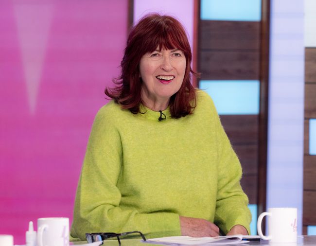 Janet Street Porter grinning in a green jumper