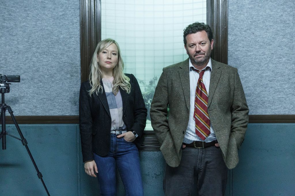 female and male detective in room