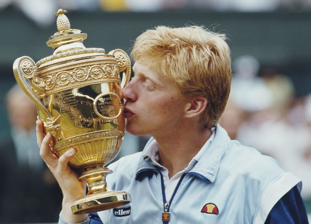 Boris Becker of Germany kisses the Gentleman's trophy to celebrate his victory over Kevin Curren 6-3, 6-7 (4-7), 7-6 (7-3), 6-4 during the Men's Singles final of the Wimbledon Lawn Tennis Championship on 7 July 1985 at the All England Lawn Tennis and Croquet Club in Wimbledon in London, England. It was Becker's 1st career Grand Slam title and his 1st Wimbledon title.
