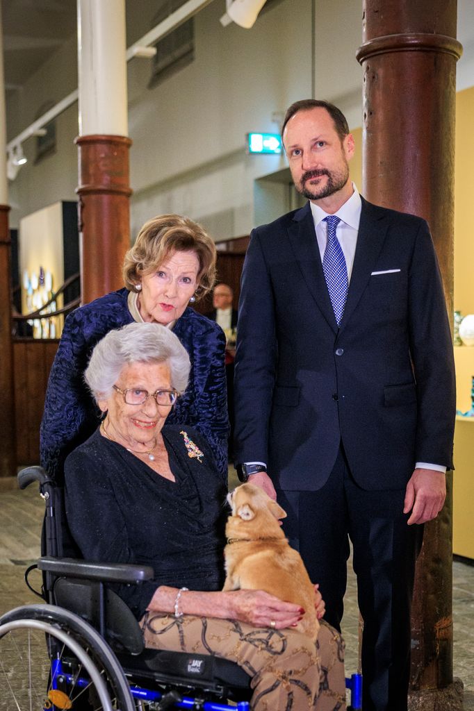 Queen Sonja with Princess Astrid in a wheelchair and Crown Prince Haakon