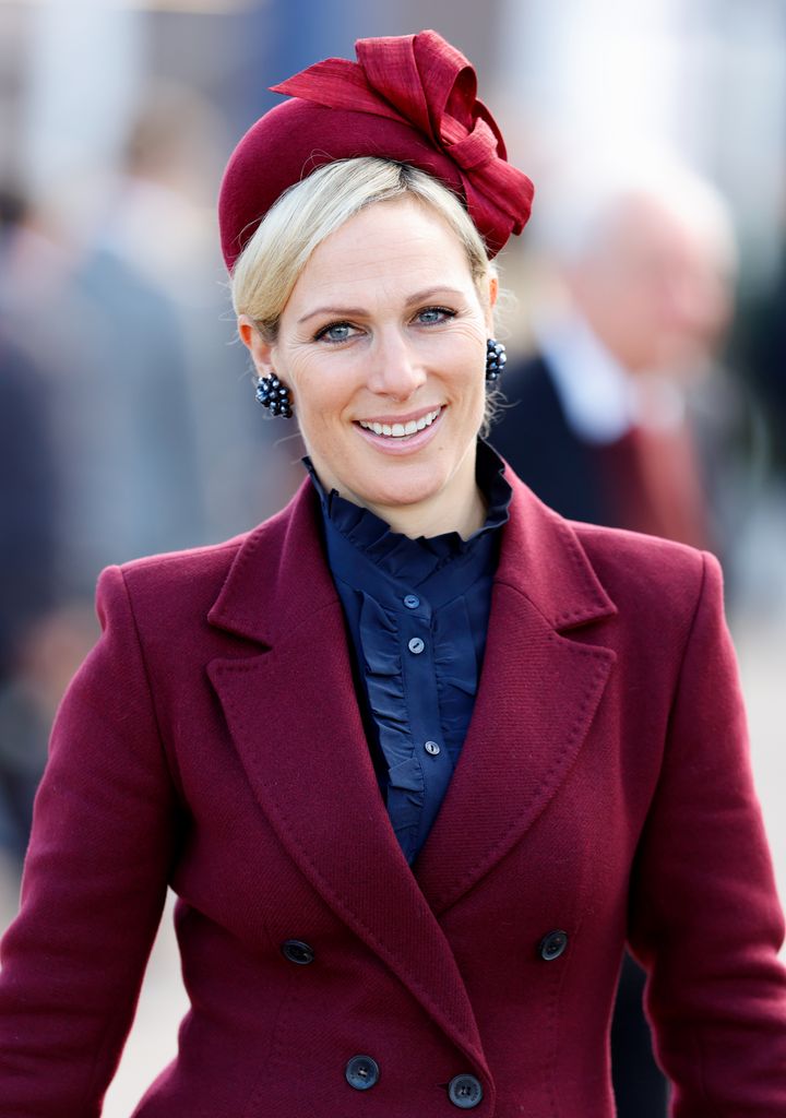 Zara Tindall in burgundy coat and fascinator