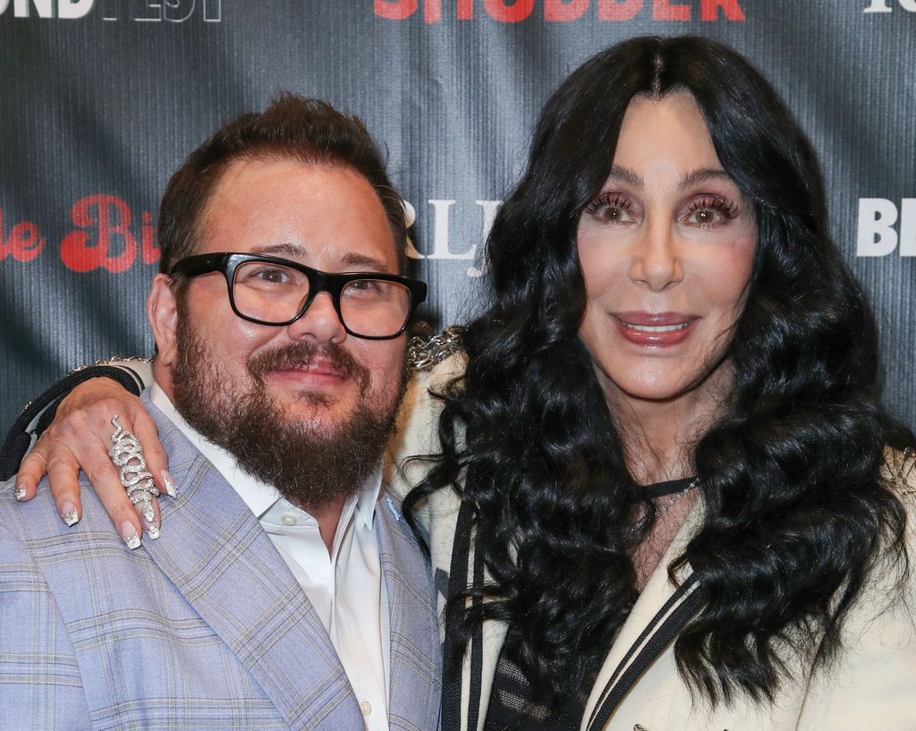 Chaz Bono and Cher smiling on the red carpet