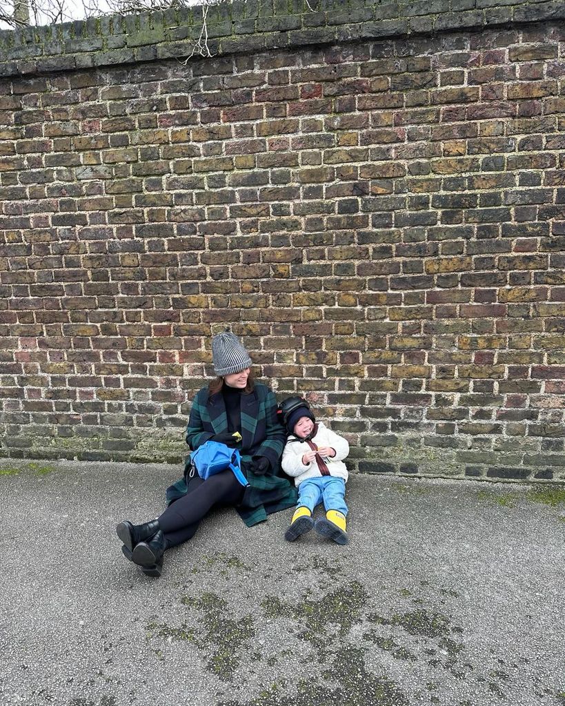 A photo of Princess Eugenie and her son August sitting on the floor outside