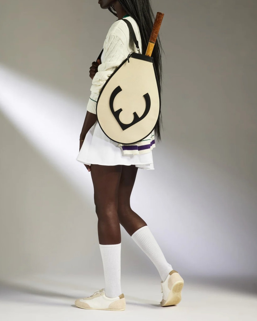 A model poses with a Antler tennis racket bag 
