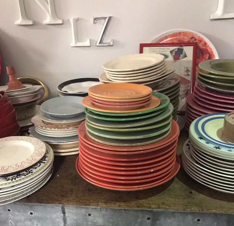 Several stacks of coloured plates