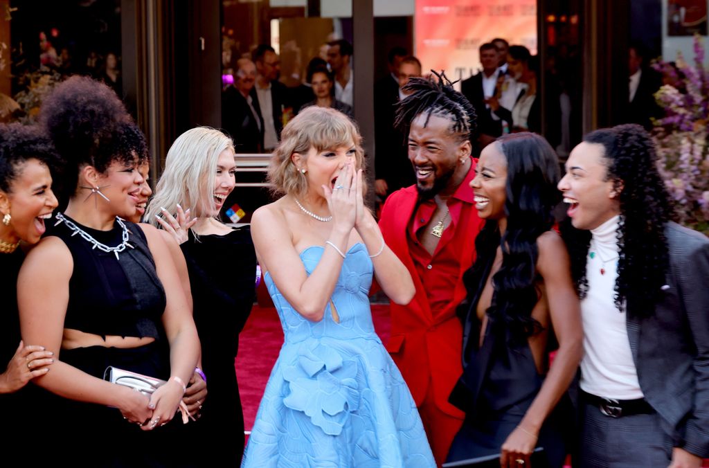 Taylor Swift with her dancers at the premiere of the Eras Tour 