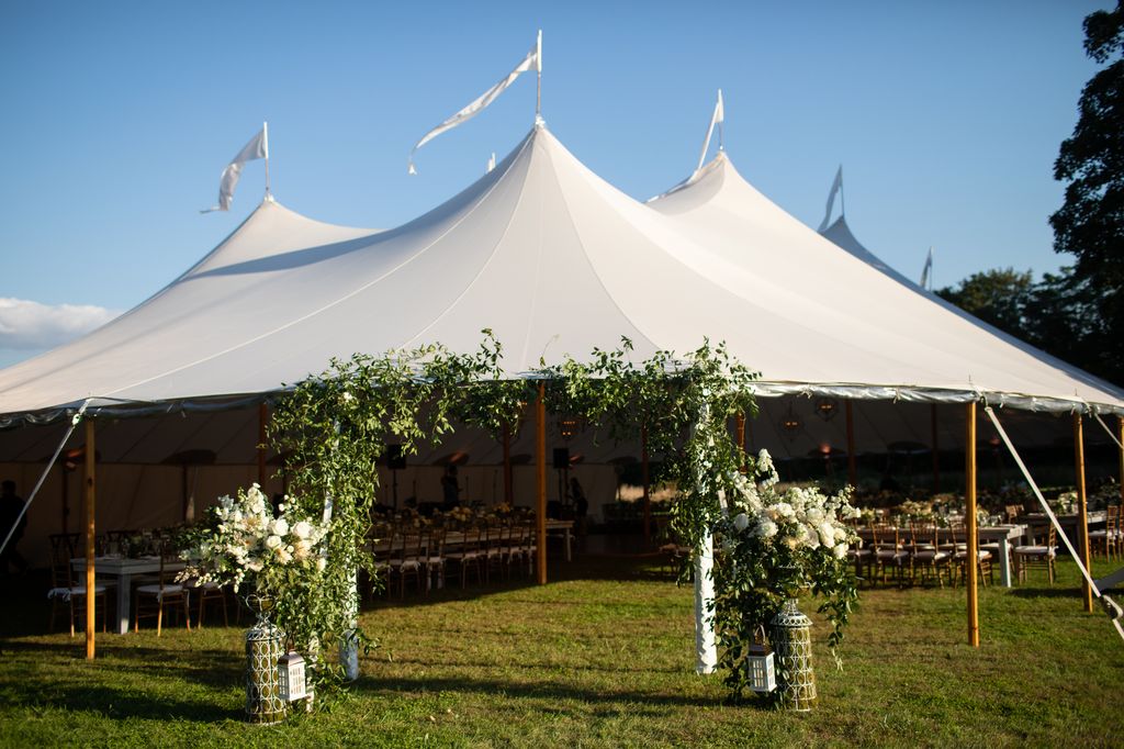 A huge event tent covers long dining tables.