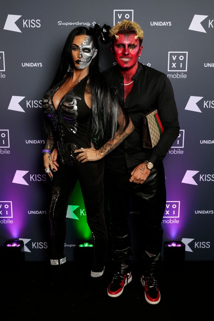 couple posing in halloween outfits 