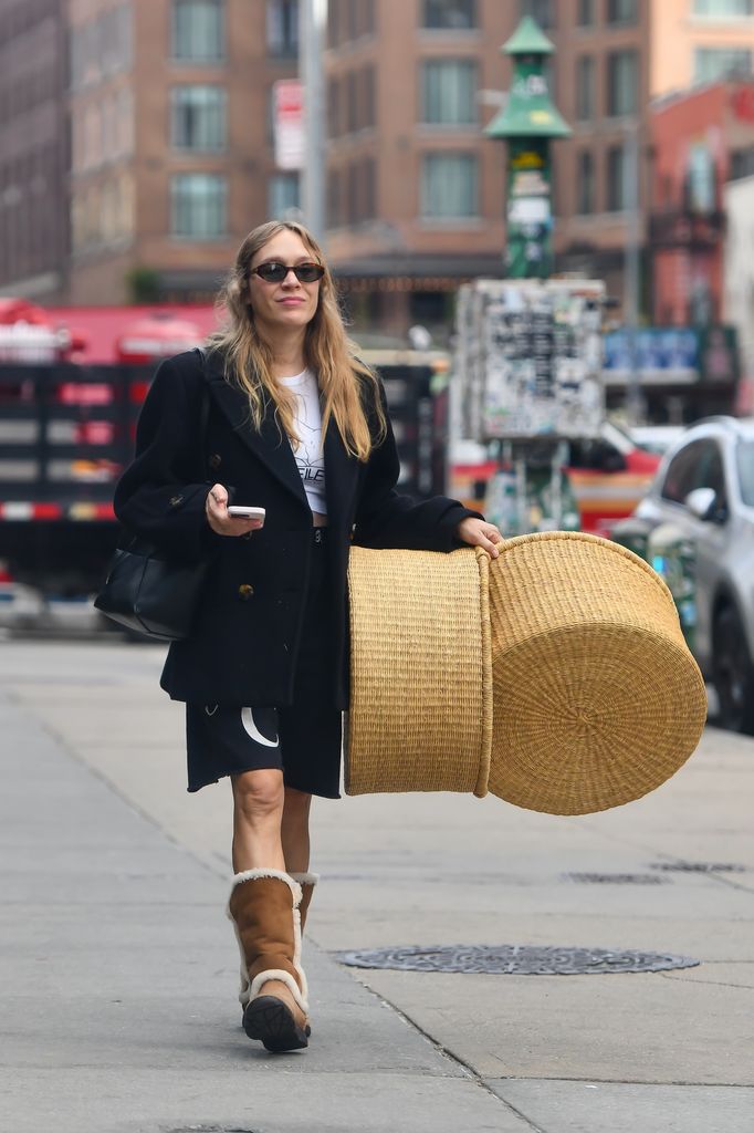 chloe sevigny in a black jacket, shorts and graphic tee