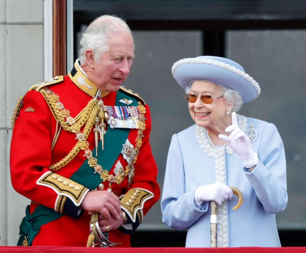 King Charles standing with the Queen on Buckingham Palace balcony