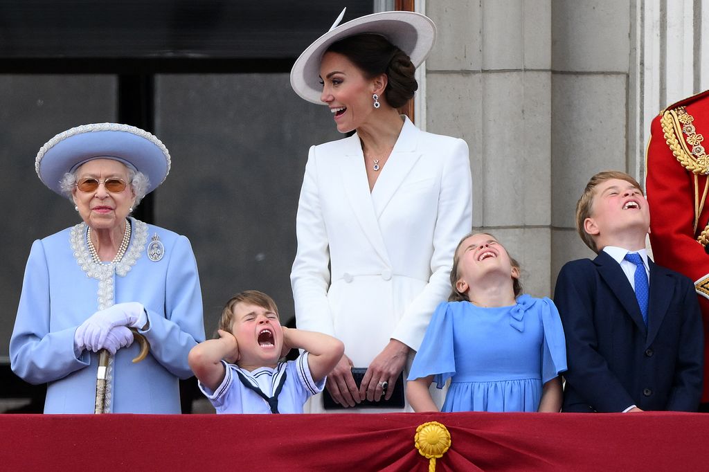 Prince Louis holds his ears as he is stood next to the late Queen Elizabeth IIs m mother Britain's Catherine, Duchess of Cambridge (C), Britain's Princess Charlotte of Cambridge (2R)and Britain's Prince George of Cambridge