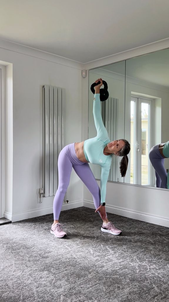 woman stretching in pastel activewear in front of a mirror 