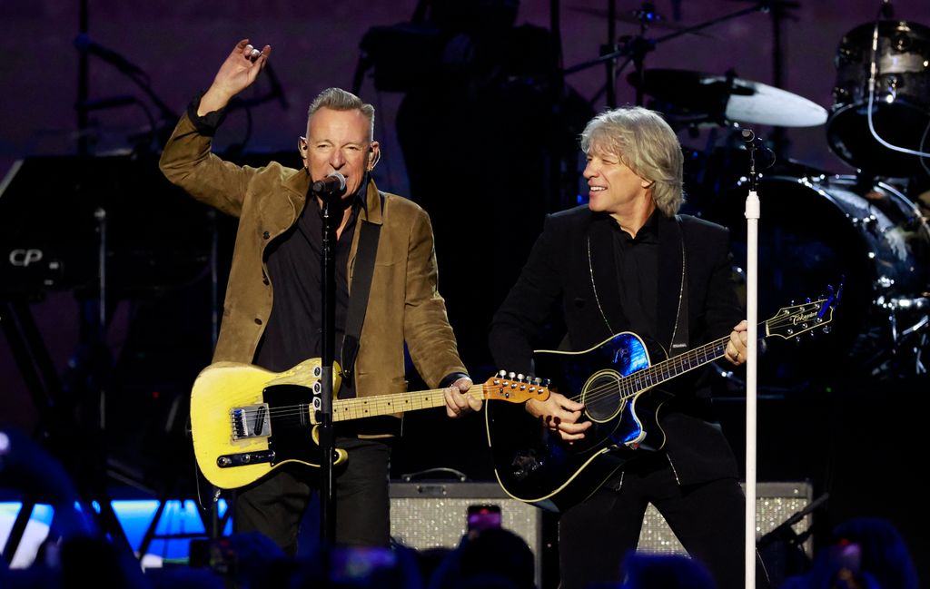 Jon Bon Jovi (R) and singer Bruce Springsteen (L) perform on stage during the 2024 MusiCares Person of the Year gala