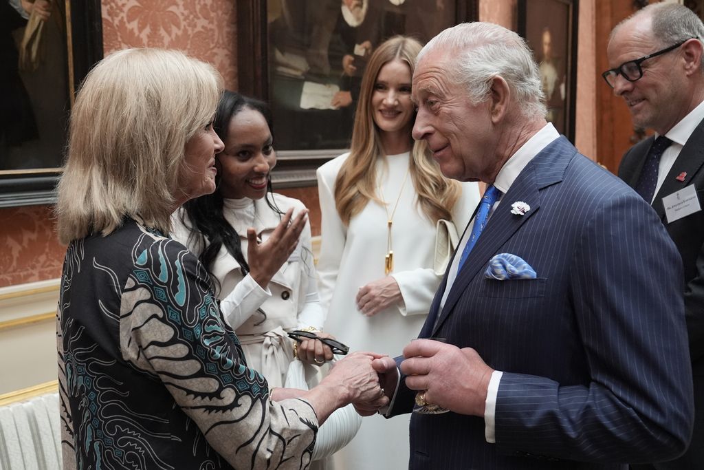 King Charles III speaks with Dame Joanna Lumley
