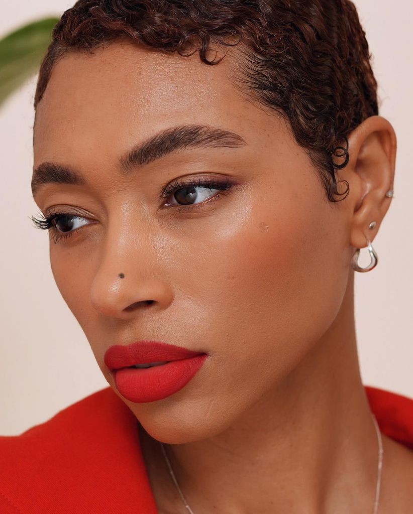 Woman with red lipstick and a red jacket and beautiful clear skin 