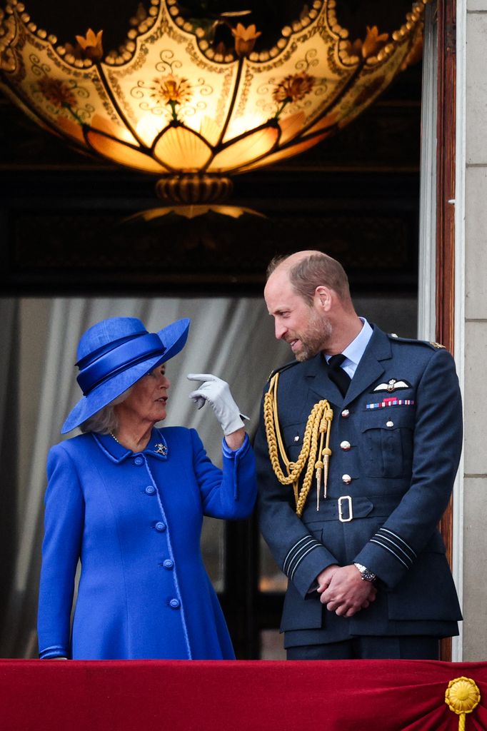 Britain's Queen Camilla talks to Britain's Prince William, Prince of Wales on the balcony of Buckingham Palace 