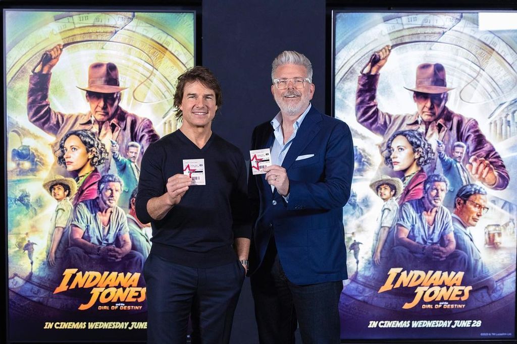 Tom Cruise holds a ticket for "Indiana Jones and the Dial of Destiny"
