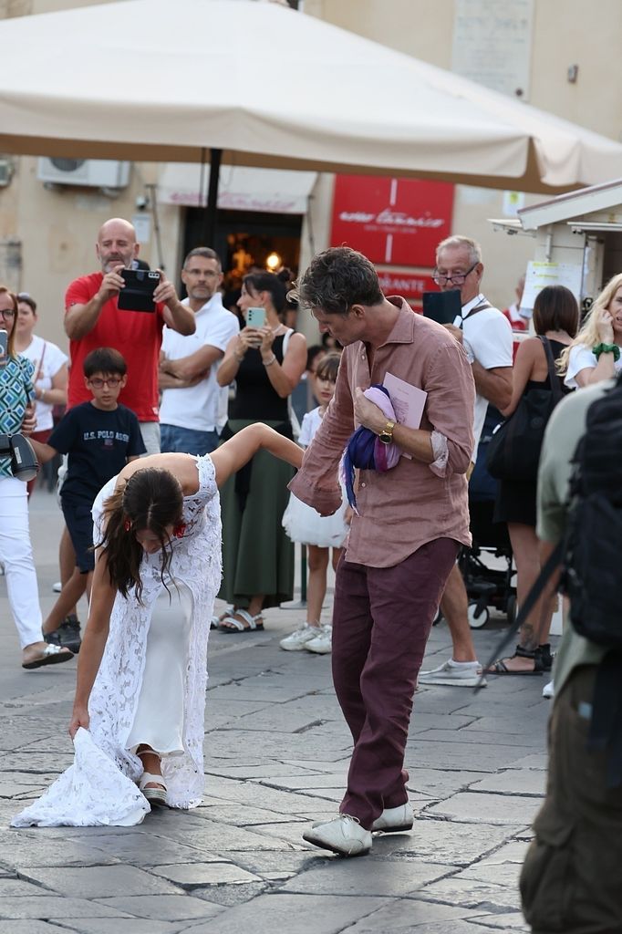 Kate Sumner picking up dress through the streets of Noto