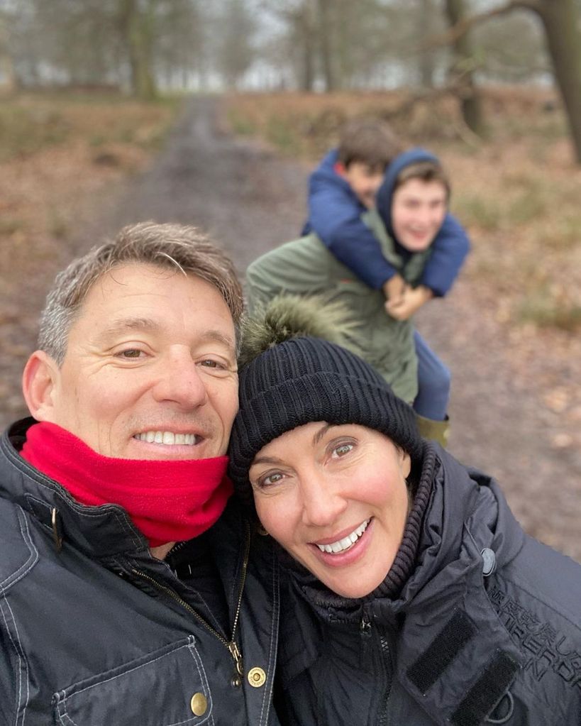 ben shephard and wife annie wearing winter clothes posing with teenage sons