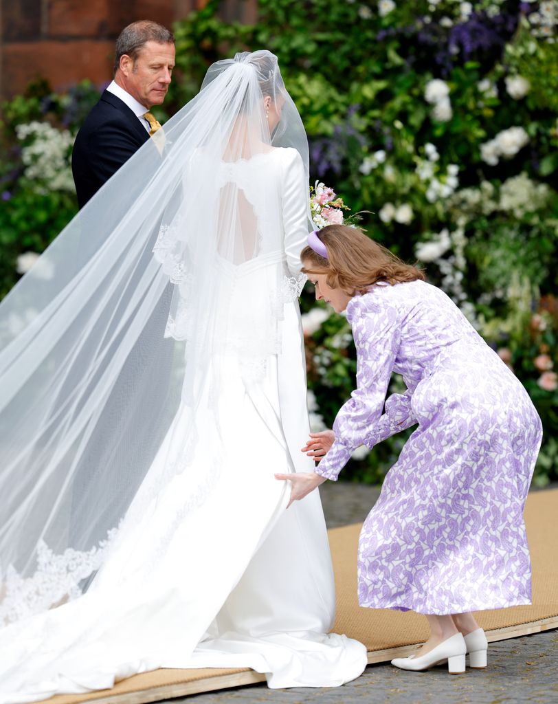 Emma Victoria Payne laying out Olivia's veil