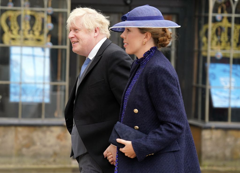 Boris Johnson and Carrie Johnson walking in formal attire