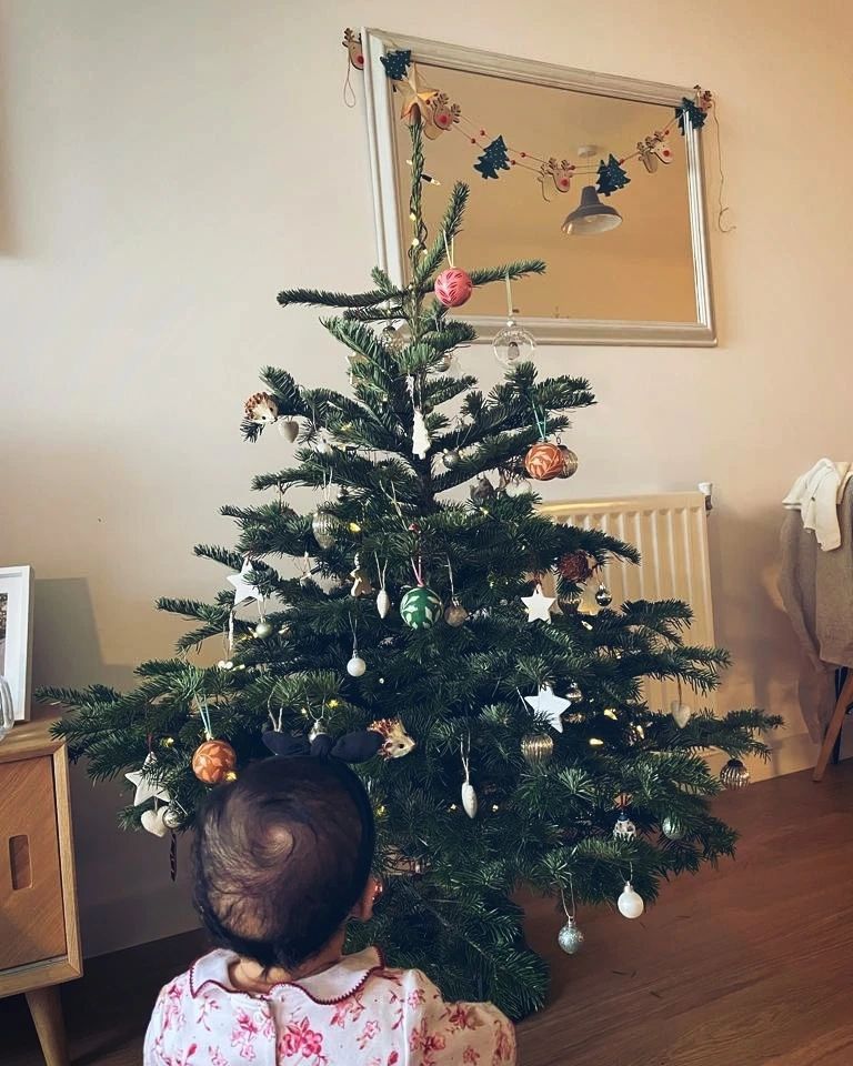Will kirk daughter sitting in front of christmas tree