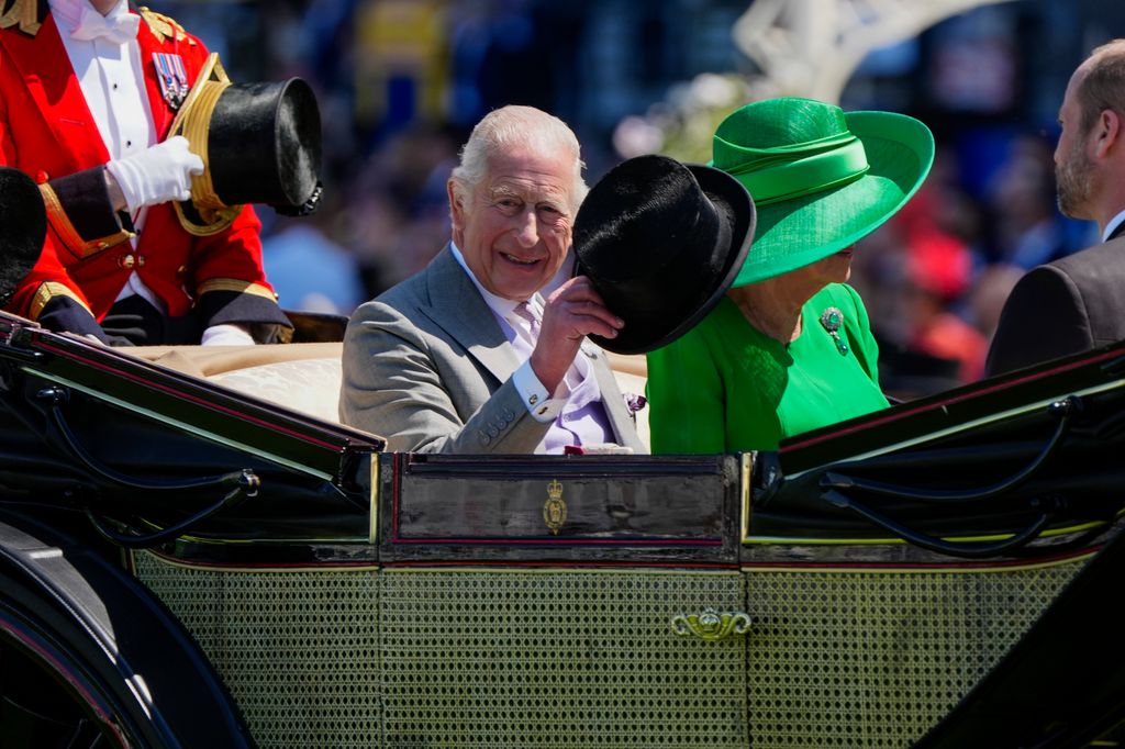 King Charles doffs his hat at the crowd