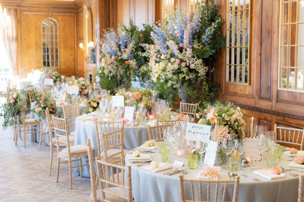 Wedding tables with floral displays in the background