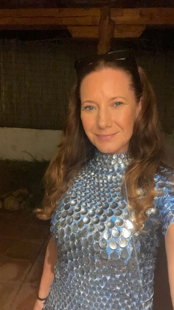 woman smiling in a glittery blue dress
